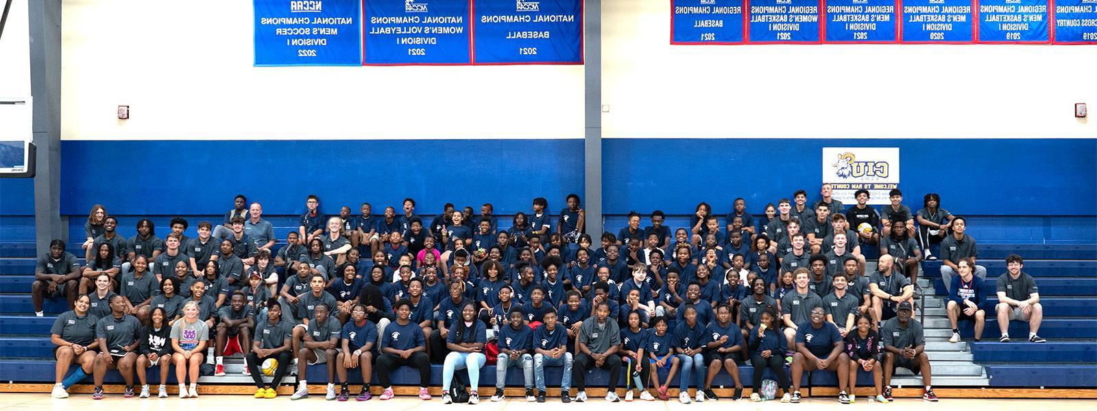 The Hope for Hope campers and members of the Rams men's and women's basketball teams pose in the Moore Fitness Center. (Photo by Noah Allard)