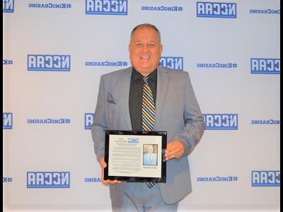 CIU AD Darren Richie displays his NCCAA Hall of Fame plaque. (Photo: NCCAA)